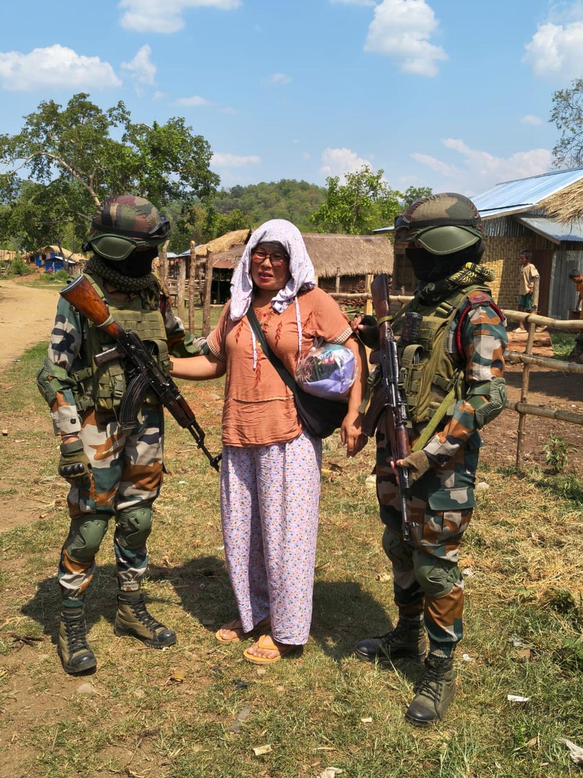 Assam Rifles personnel with the Tangkhul Naga woman, after securing her release from a Myanmar-based Kuki extremist group on Saturday.