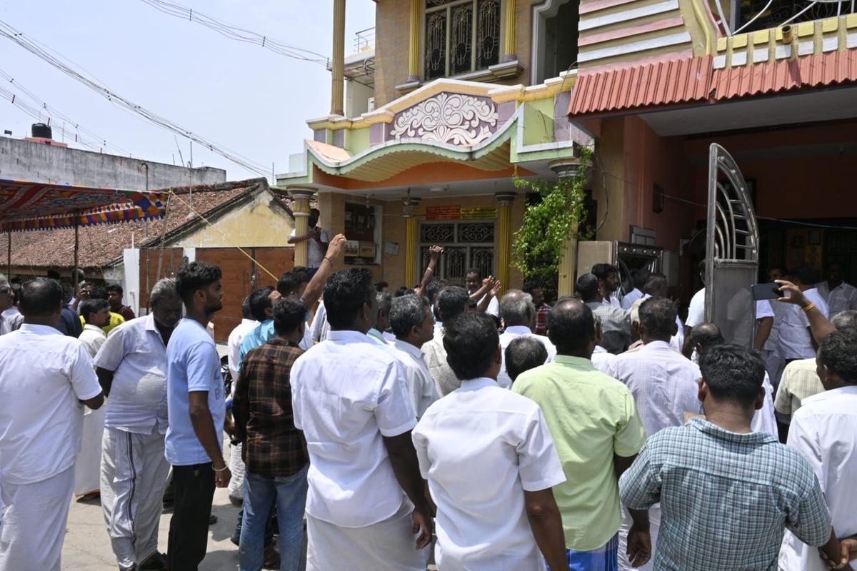 AIADMK supporters raise slogans outside Mr. Ramachandran’s house during the DVAC searches, at Sevur, near Arani
