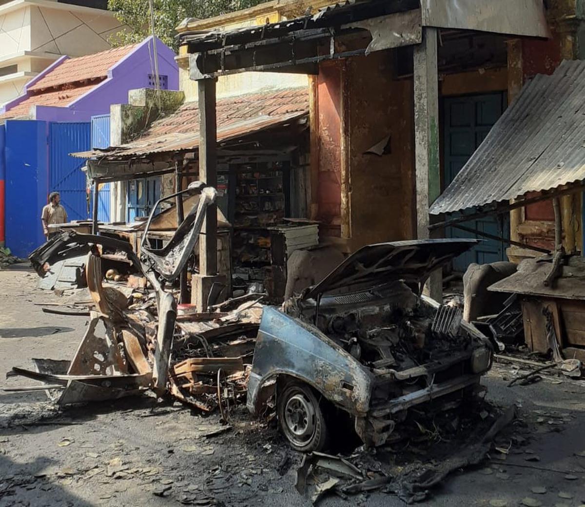 Mangled remains of the car which was gutted in an LPG cyliner explosion in front of Kottai Eswaran Kovil Street in Coimbatore city on October 23, 2022