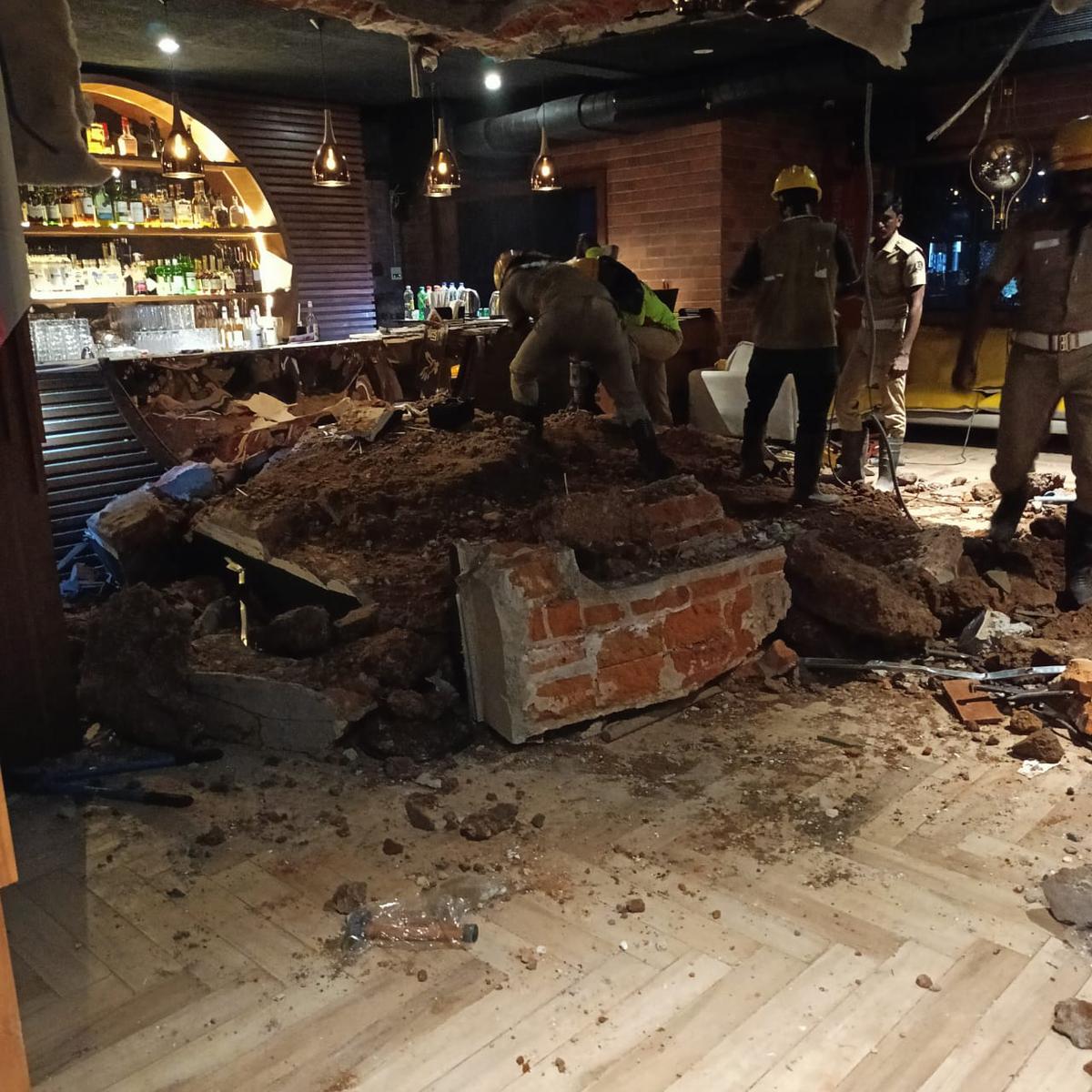 Personnel of the police and the Tamil Nadu Fire and Rescue Services clearing the debris inside Sekhmet Club on Thursday.