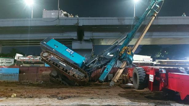 Piling rig machine falls near Metro Rail construction site