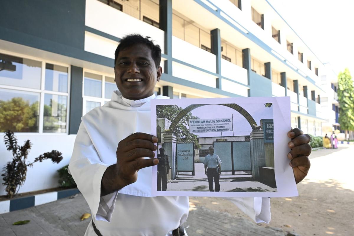 Father Sumesh Joseph Illikkaparambil holds up the photograph taken during Father Prevost’s visit in 2006