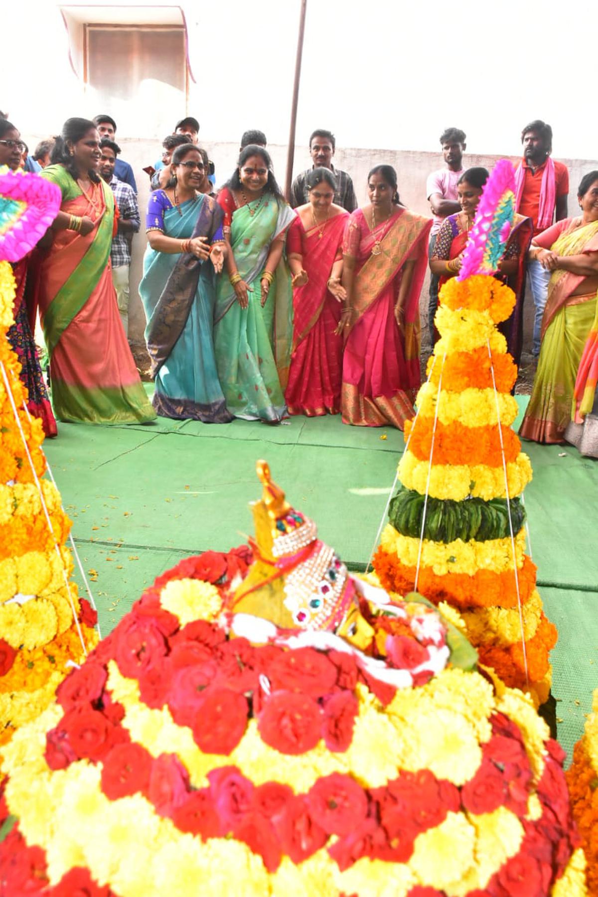 BRS MLC K. Kavitha playing Bathukamma with party women workers in Bodhan.
