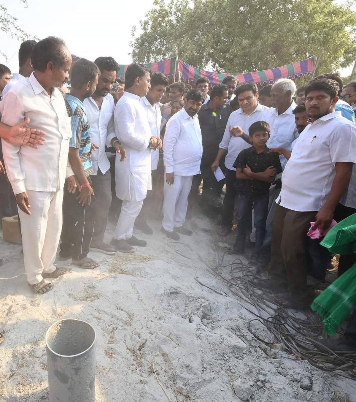 BRS leaders looking at a newly-sunk borewell which did not find any water at Mushampalli village in Nalgonda dist on Monday.