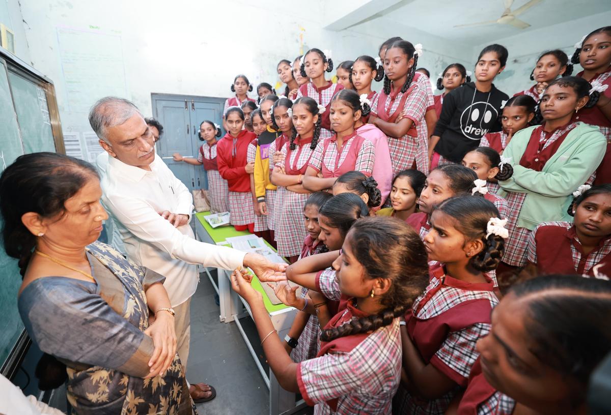 A student of a residential school at Palamakula in Rangareddy district showing a scar on her arm to BRS leader Harish Rao on Saturday.