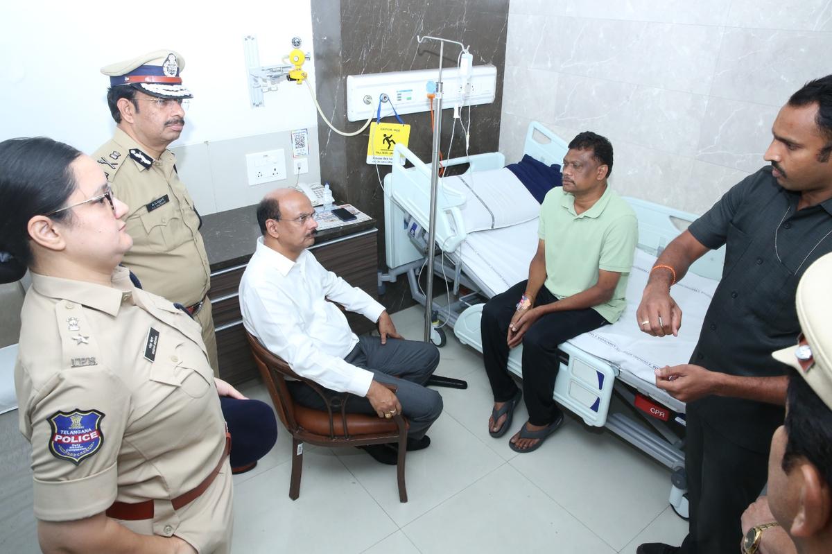 Telangana DGP B. Shivadhar Reddy and Hyderabad Commissioner of Police V. C. Sajjanar and other senior officers on Sunday with DCP (South-East) S. Chaitanya Kumar’s gunman BSN Murthy at Yashoda Hospital. 
