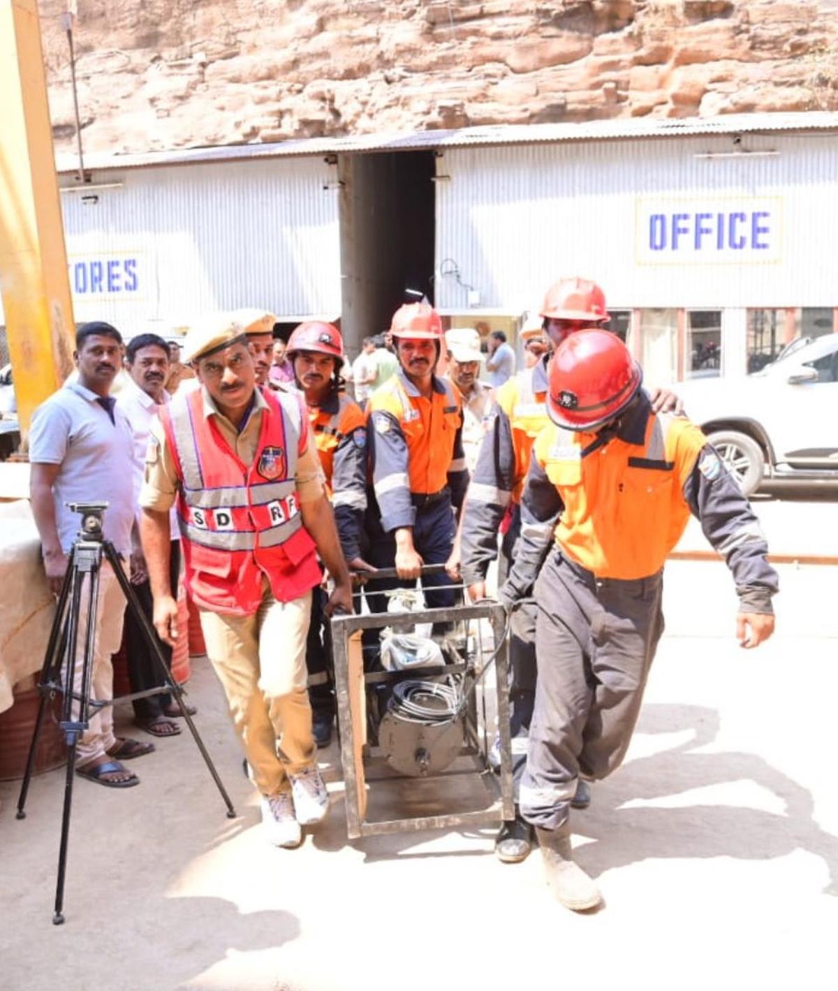 Members of a rescue team taking an equipment towards the SLBC tunnel near Domalapenta in Nagarkurnool district on Monday to speed up finding more persons trapped under the debris. Members of a rescue team taking an equipment towards the SLBC tunnel near Domalapenta in Nagarkurnool district on Monday to speed up finding more persons trapped under the debris.