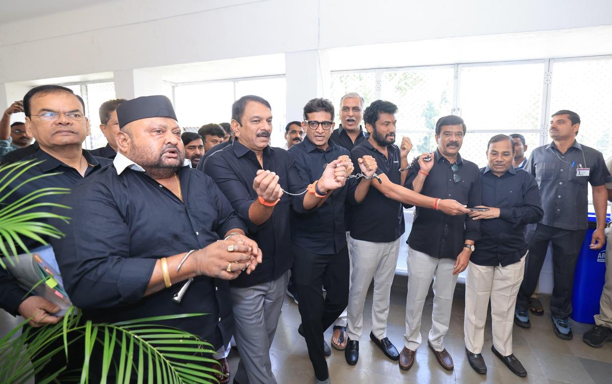 BRS leaders sporting handcuffs at the LP office expressing solidarity with Lagcherla farmers in Hyderabad on Tuesday.