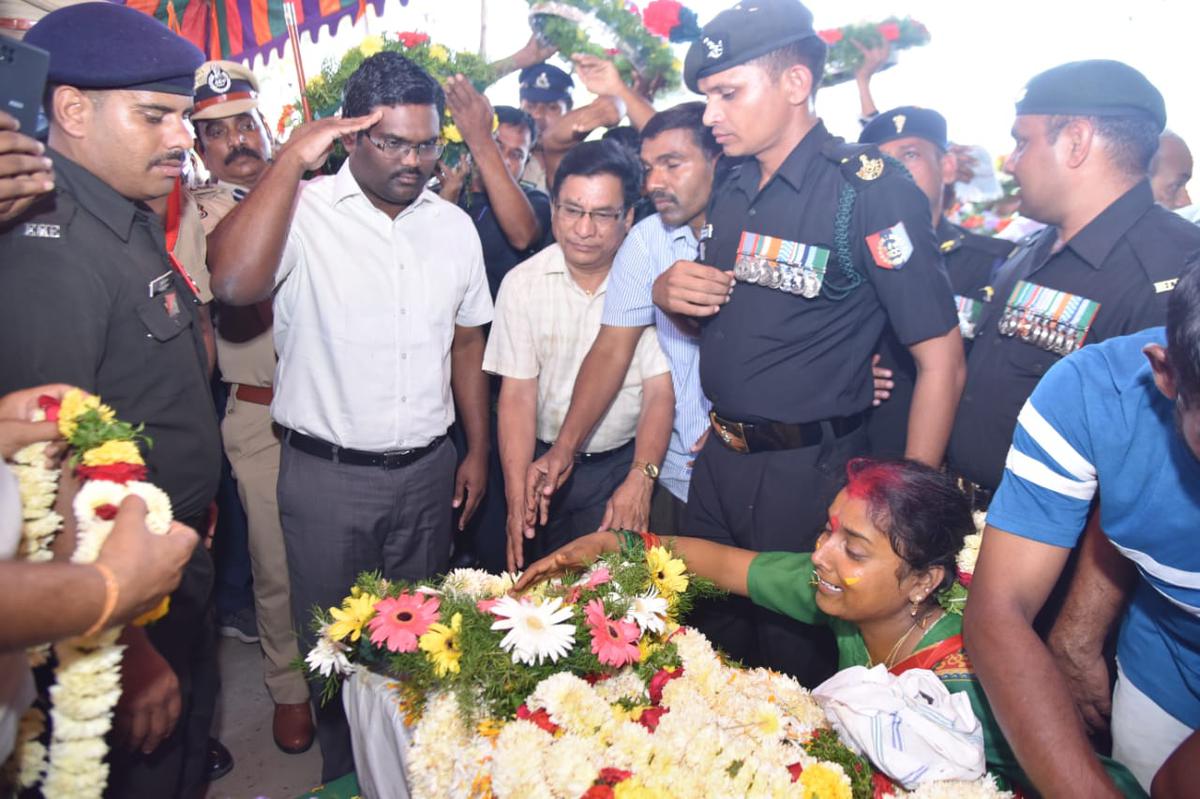 Nizamabad Collector Rajiv Gandhi Hanumanthu paying tributes to Lance Naik Niradi Ganga Prasad, who was drowned in flash floods in the Teesta river in Sikkim, at his village Kummanpally in Nizamabad district on October 8, 2023
