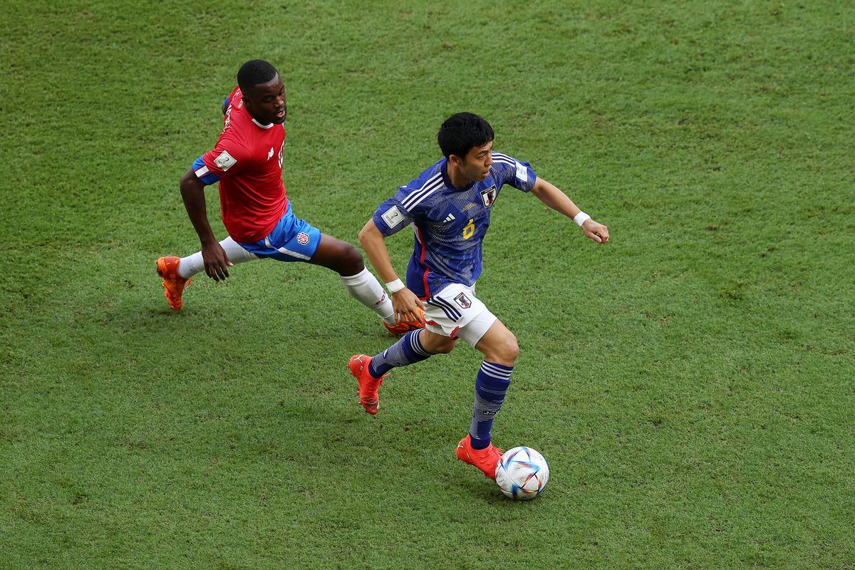 Wataru Endo of Japan controls the ball against Joel Campbell of Costa Rica during the FIFA World Cup Qatar 2022 Group E match between Japan and Costa Rica at Ahmad Bin Ali Stadium on November 27, 2022, in Doha, Qatar.