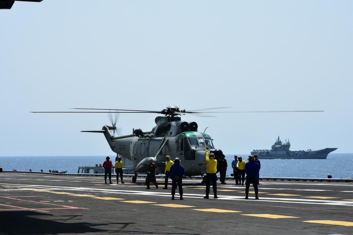 A Sea King helicopter on the flight deck of INS Vikramaditya. INS Vikrant is seen in the background.