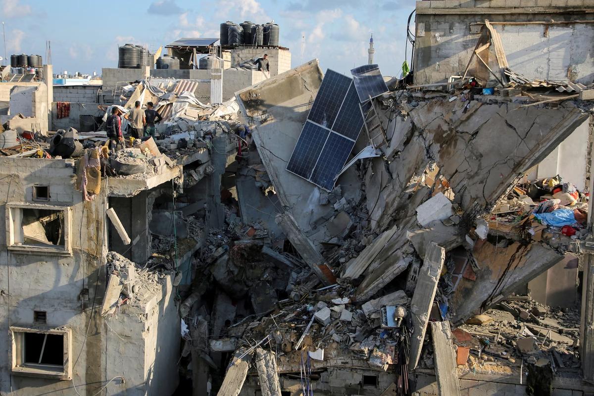 Palestinians inspect the site of an Israeli strike on a house, amid the ongoing conflict between Israel and the Palestinian Islamist group Hamas, in Rafah, in the southern Gaza Strip on May 7, 2024. 