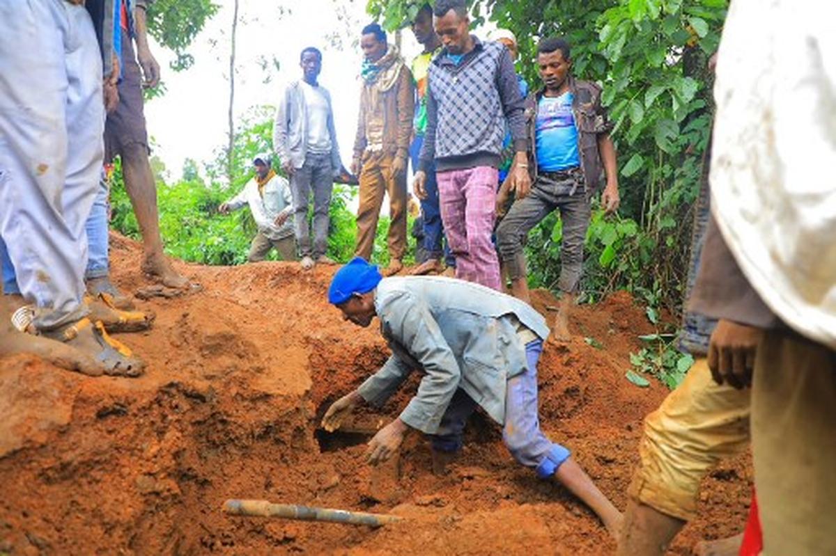 This grab made from a handout footage released by the Gofa Zone Government Communication Affairs Department on July 22, 2024, shows people looking for victims at the bottom of a landslide that occurred in the Geze-Gofa district.