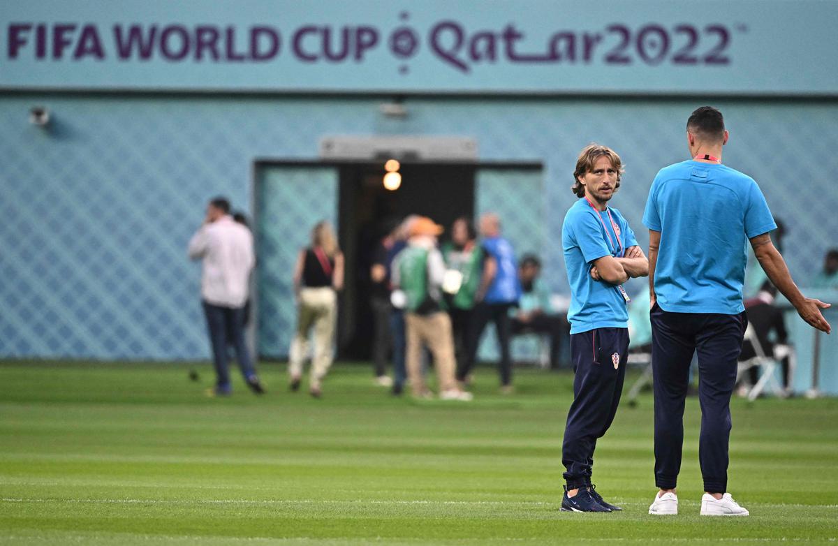 Croatia’s midfielder Luka Modric (left) and Croatia’s defender Dejan Lovren walk on the pitch prior to the Qatar 2022 World Cup third-place play-off football match between Croatia and Morocco at Khalifa International Stadium in Doha on December 17, 2022. 