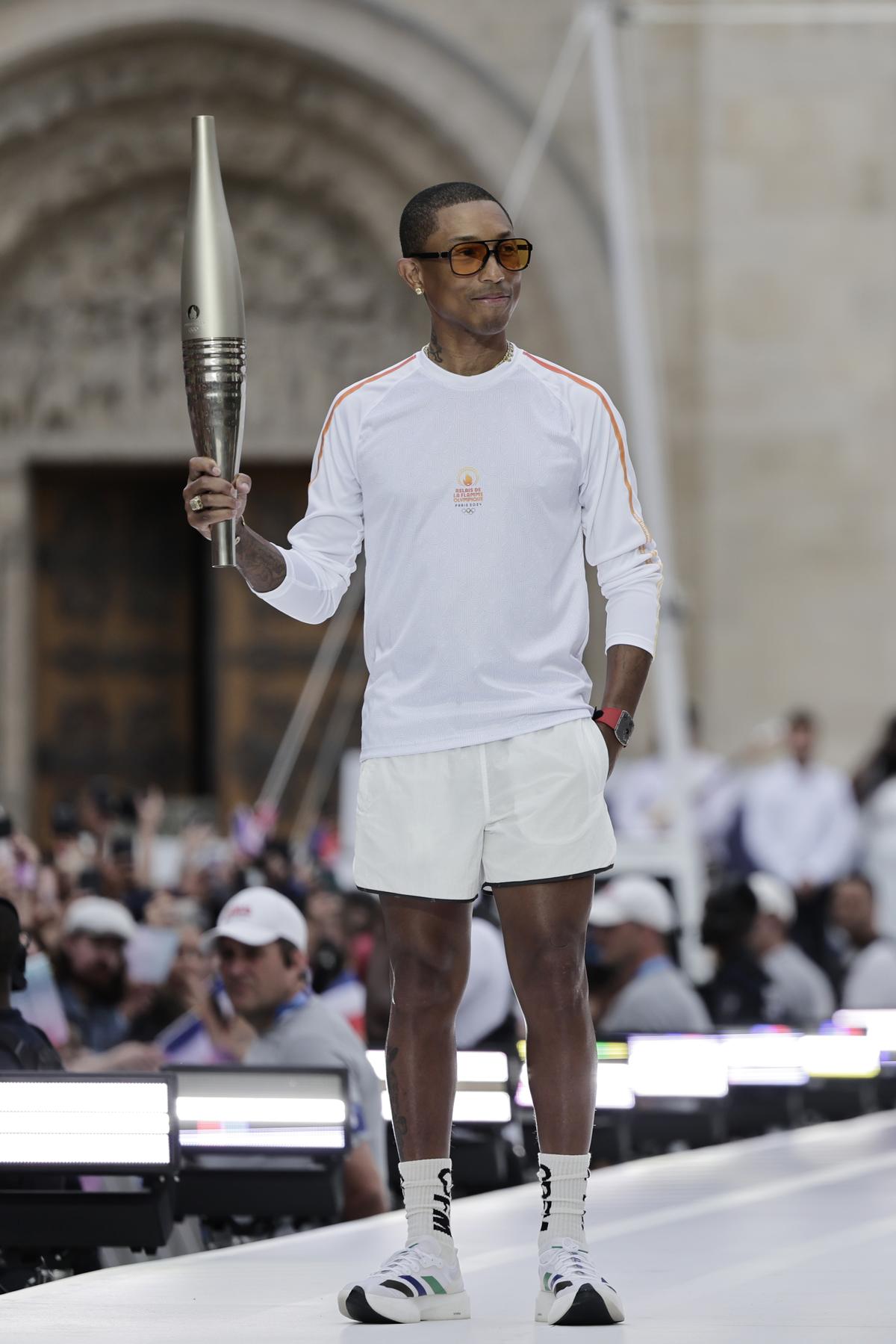 US rapper and artist Pharell Williams, who also helms the LVMH men’s collections, during the 2024 Paris Olympic Games Torch Relay at Saint-Denis, outside Paris. US rapper and artist Pharell Williams, who also helms the LVMH men’s collections, during the 2024 Paris Olympic Games Torch Relay at Saint-Denis, outside Paris.