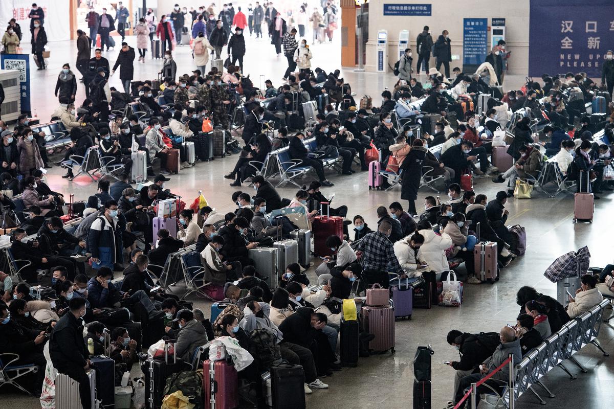 Passengers wait at the departure area of Hankou railway station in Wuhan.