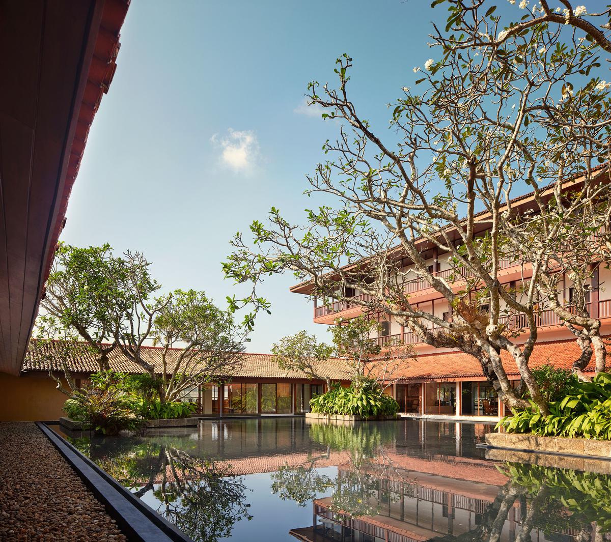 The lobby is built around a pool that houses aÂ frangipani tree, which, a sign says, was rooted to the ground even before the construction of the hotel in 1969. Photo: Special Arrangement