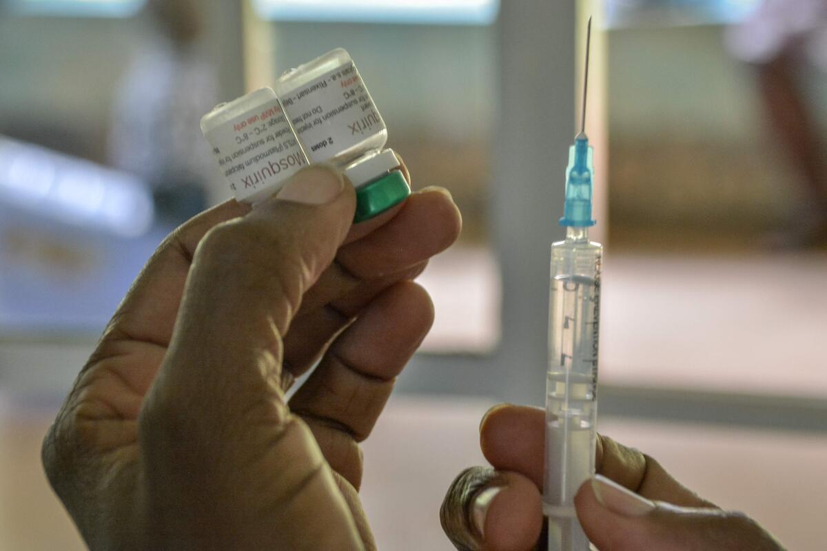 A health worker prepares a malaria vaccination. The World Health Organisation endorsed the use of the malaria vaccine Mosquirix on children aged five months to five years in October 2021.