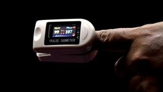 A person uses a pulse oximeter to record the oxygen level in blood. The test positivity rate in Kozhikode which was above 15% has declined to 9.06%. K. RAGESH