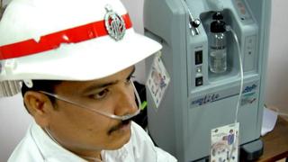 VISAKHAPATNAM, 13/09/2008: A constable inhaling enriched oxygen from the oxygen concentrator, requisitioned by the city police for the first time in AP Police for the benefit of constables who are exposed to vehicular emissions, dust and pollution for eight to 10 hours at a stretch, in Visakhapatnam on September 13, 2008. Many of constables, particularly those posted in high pollution zones like the industrial belt and old town are forced to breathe polluted air for long periods and are susceptible to respiratory and other diseases. The oxygen concentrators, manufactured by AirSep Corp, USA, will help the constables to fight the fatigue and stress caused by air pollution. Traffic constables can inhale fresh oxygen after duty for the time recommended by doctors to neutralise the ill-effects of breathing polluted air. Photo: C.V. Subrahmanyam