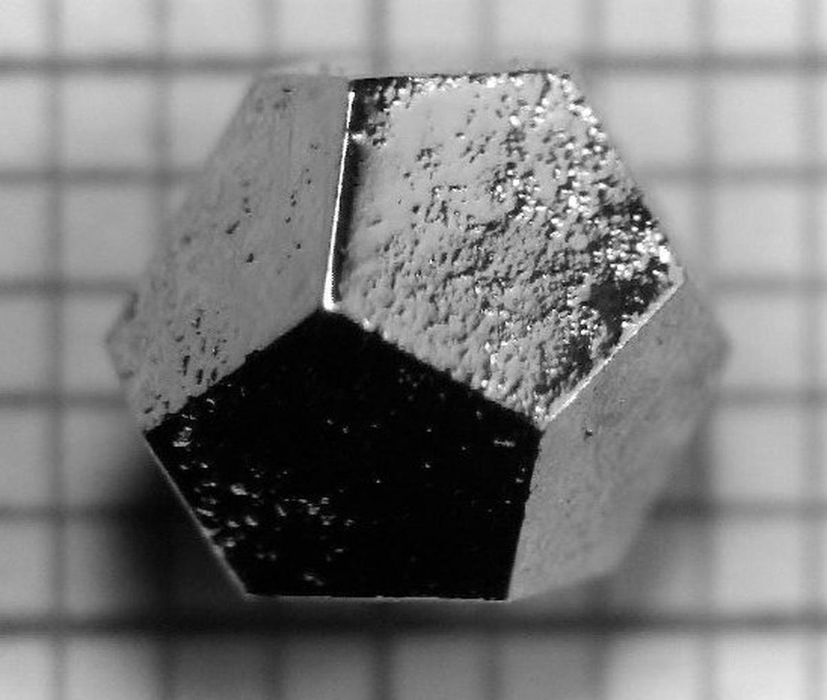 Photograph of a single-grain icosahedral Ho-Mg-Zn quasicrystal made in the lab. The edges are 2.2 mm long.