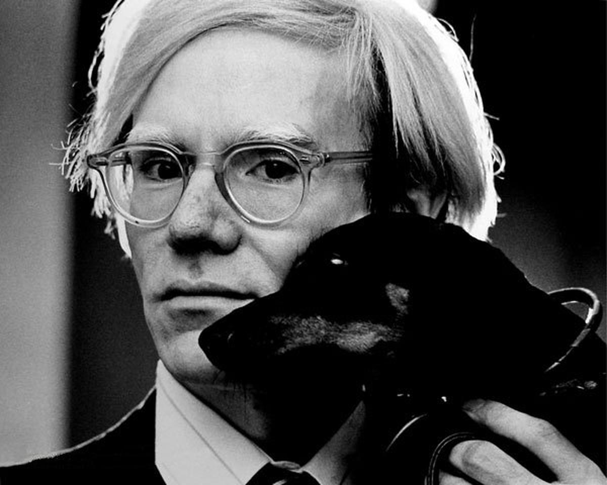 Andy Warhol with his pet dachshund, 1973.