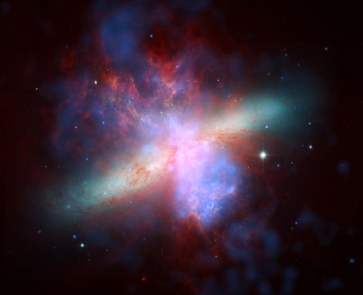Composite image of galaxy M82 with X-ray data recorded by the Chandra telescope (blue);  infrared light recorded by the Spitzer telescope (red);  hydrogen emissions recorded by the Hubble space telescope (orange), and the bluest visible light (yellow-green).  Posted in 2006.