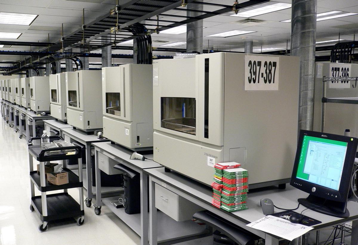 A row of DNA sequencing machines. According to accounts from researchers in government-funded institutions, Indian public universities often face protracted procurement cycles, sometimes exceeding six months.