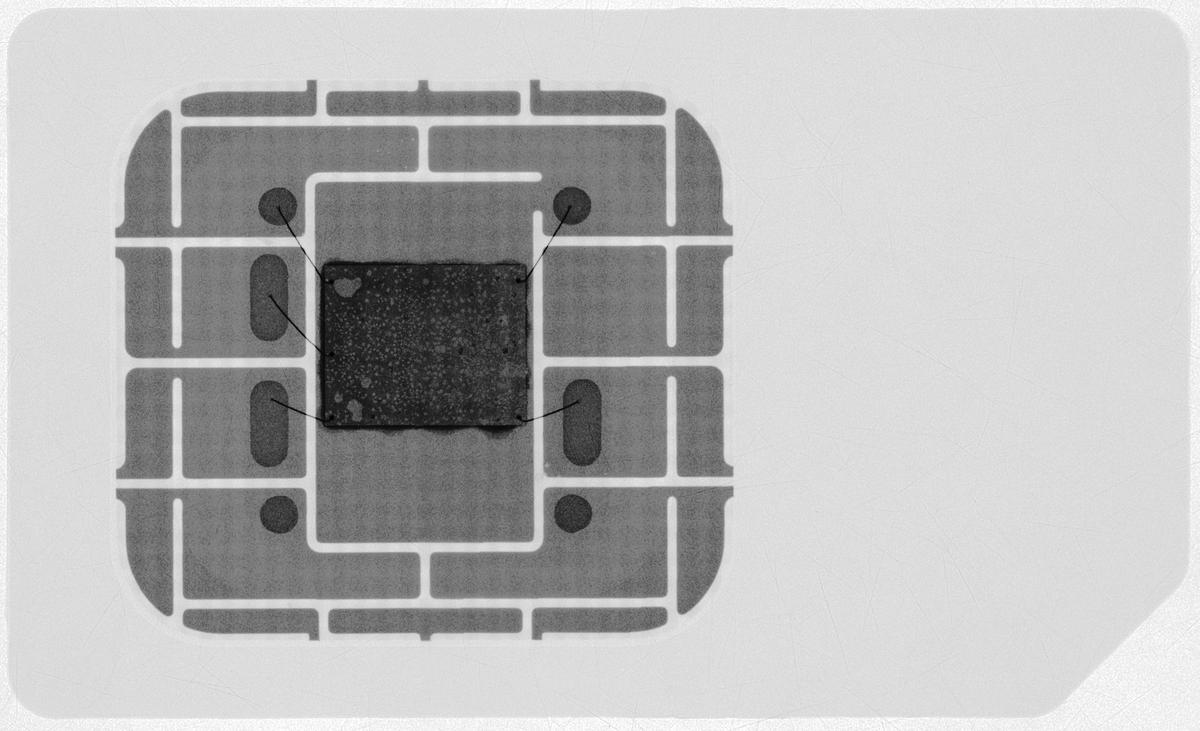 An X-ray of a mini-SIM showing the microchip, the metal contacts, and the wires connecting them.