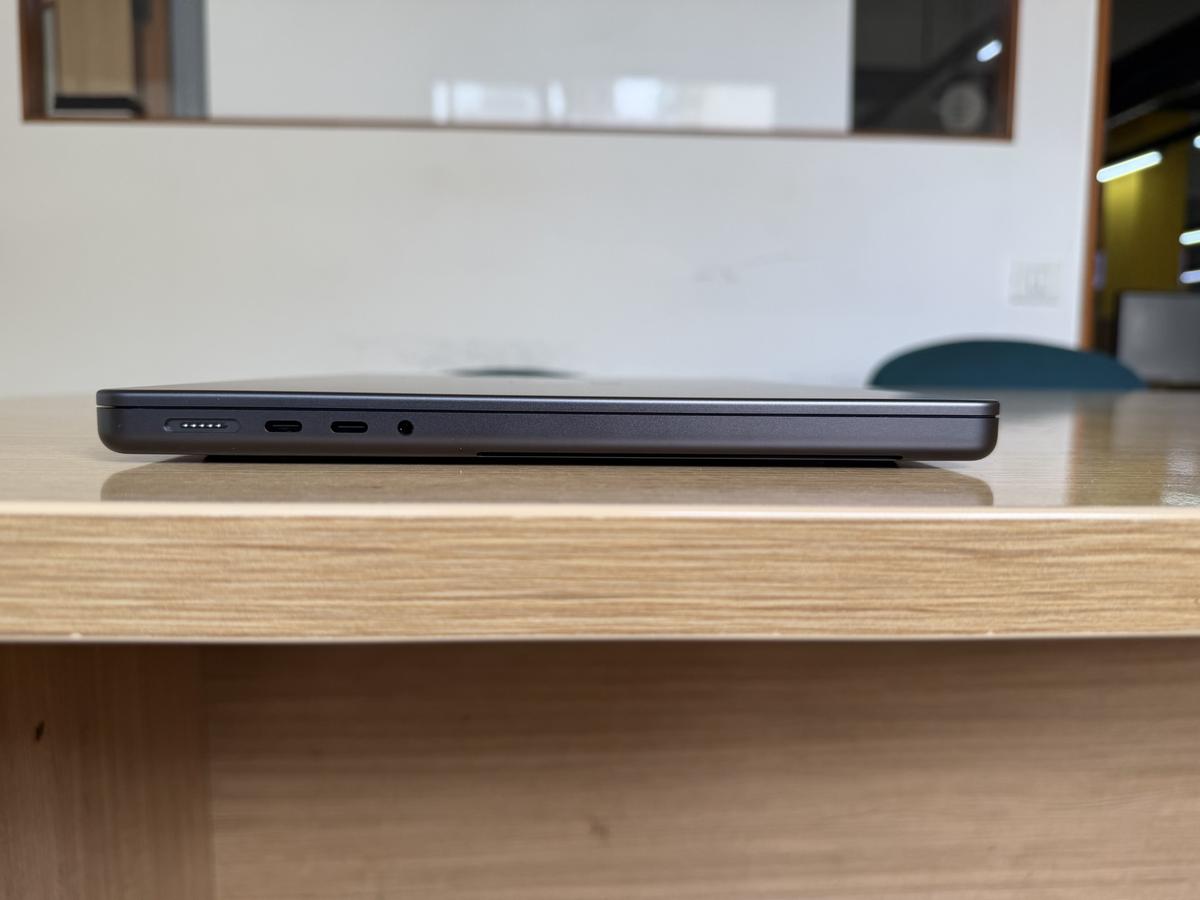 A side view of the Apple M5 MacBook Pro, showing the Thunderbolt 4 ports, headphone jack, and charging port