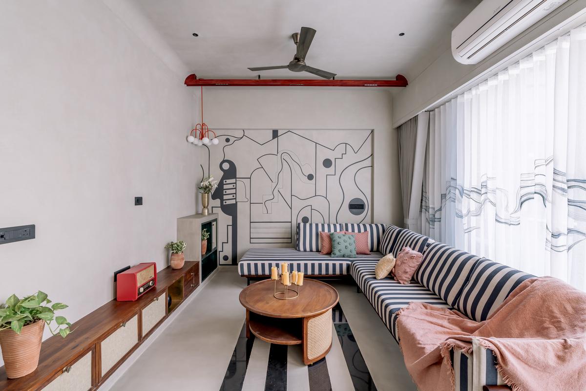 Contemporary artwork takes centrestage in this living room accent wall.