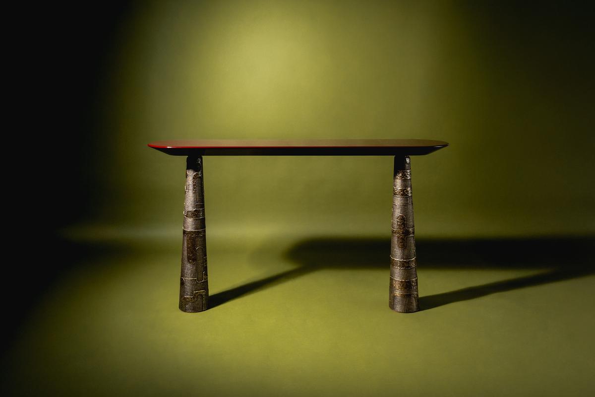 Maske Console in lacquered stone top on cast bronze legs.