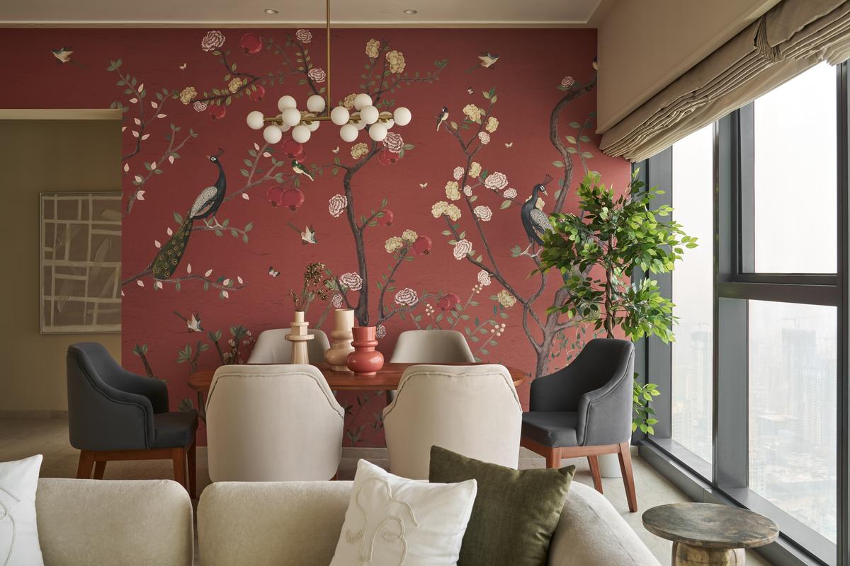 A carnival of rust covers the wall in the living cum dining space. 