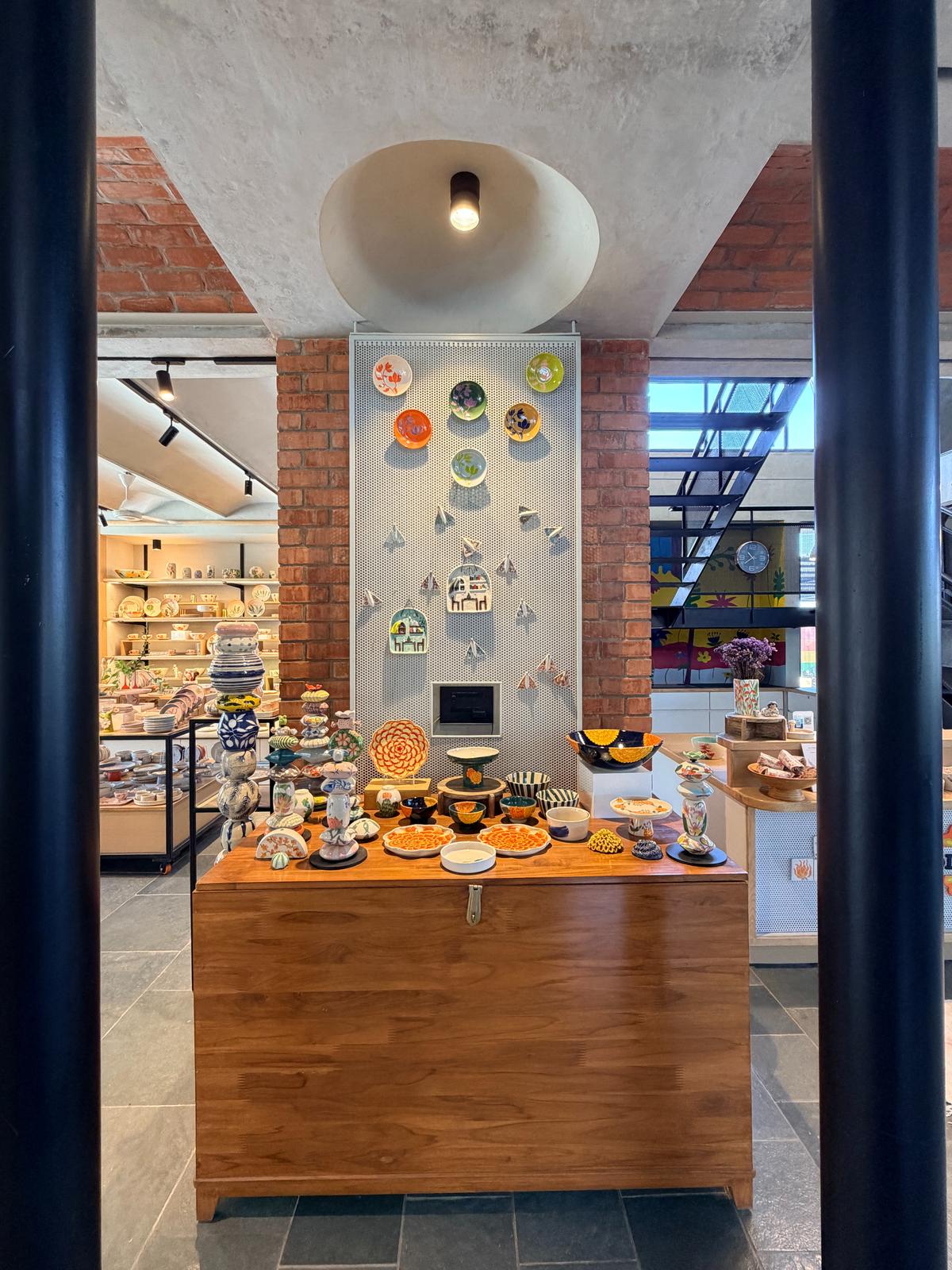 Juxtaposition of ceramic Totem and objects against the ceramic, brick and metal structure.
