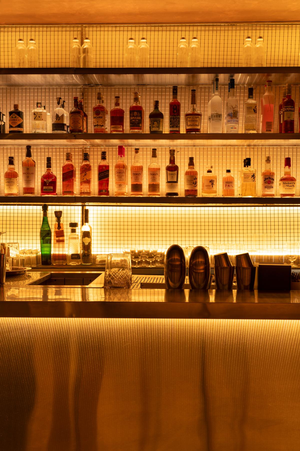 Layered shelving with a textured, backlit backdrop. Layered shelving with a textured, backlit backdrop.