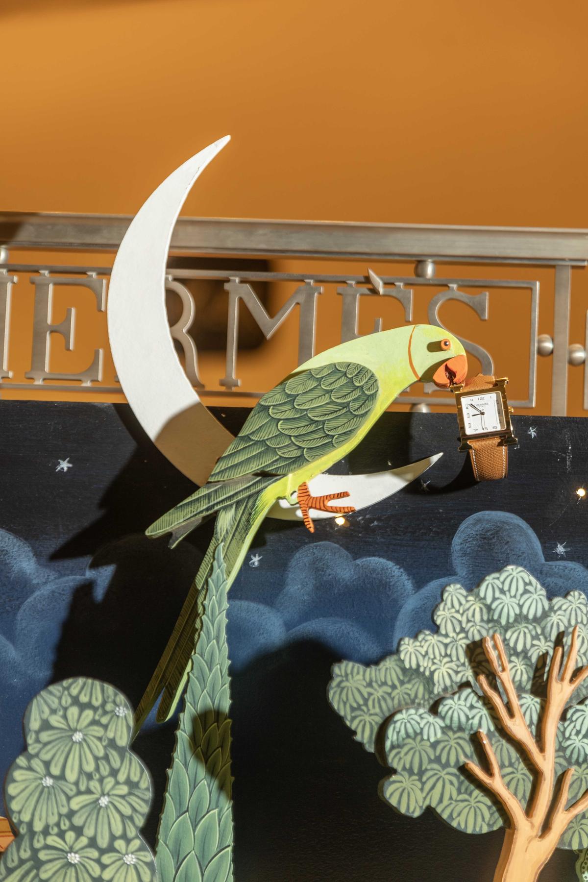 Perched on a crescent moon is the parrot, a storyteller and the artist’s muse. Perched on a crescent moon is the parrot, a storyteller and the artist’s muse.