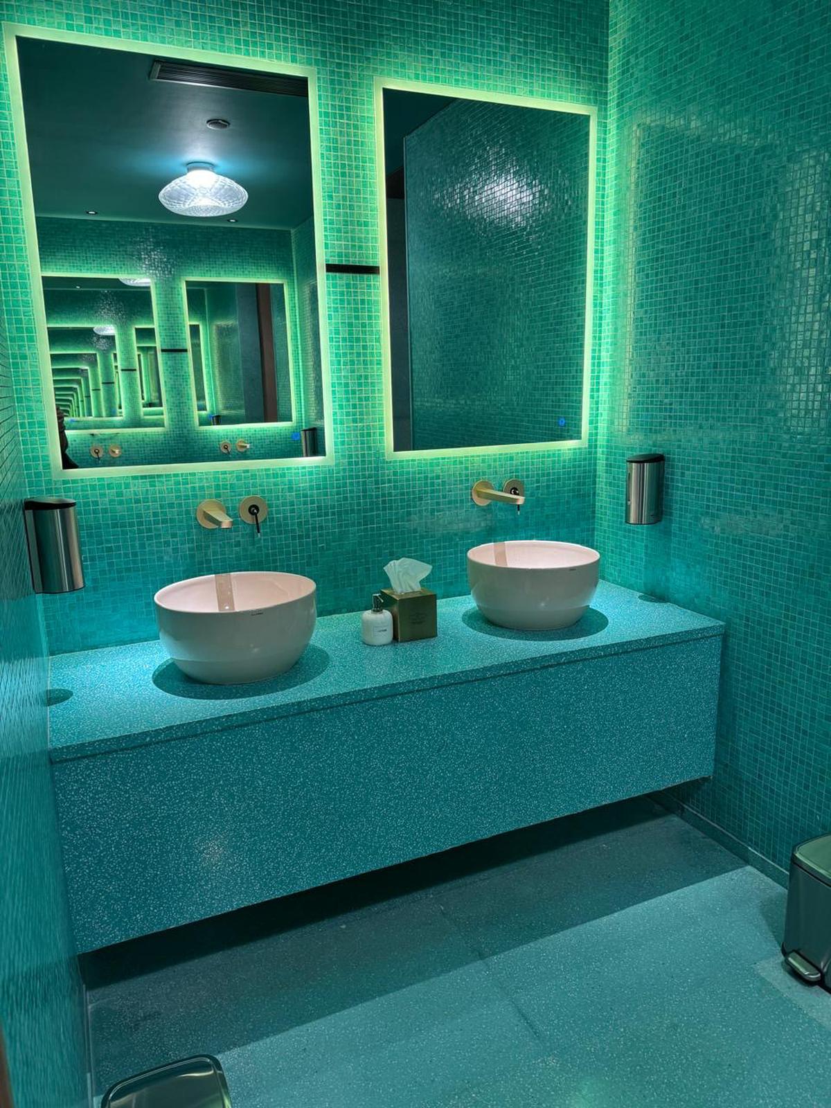 Bathrooms at Nilaya Anthology, Mumbai with in-situ counters and mosaic tile walls.