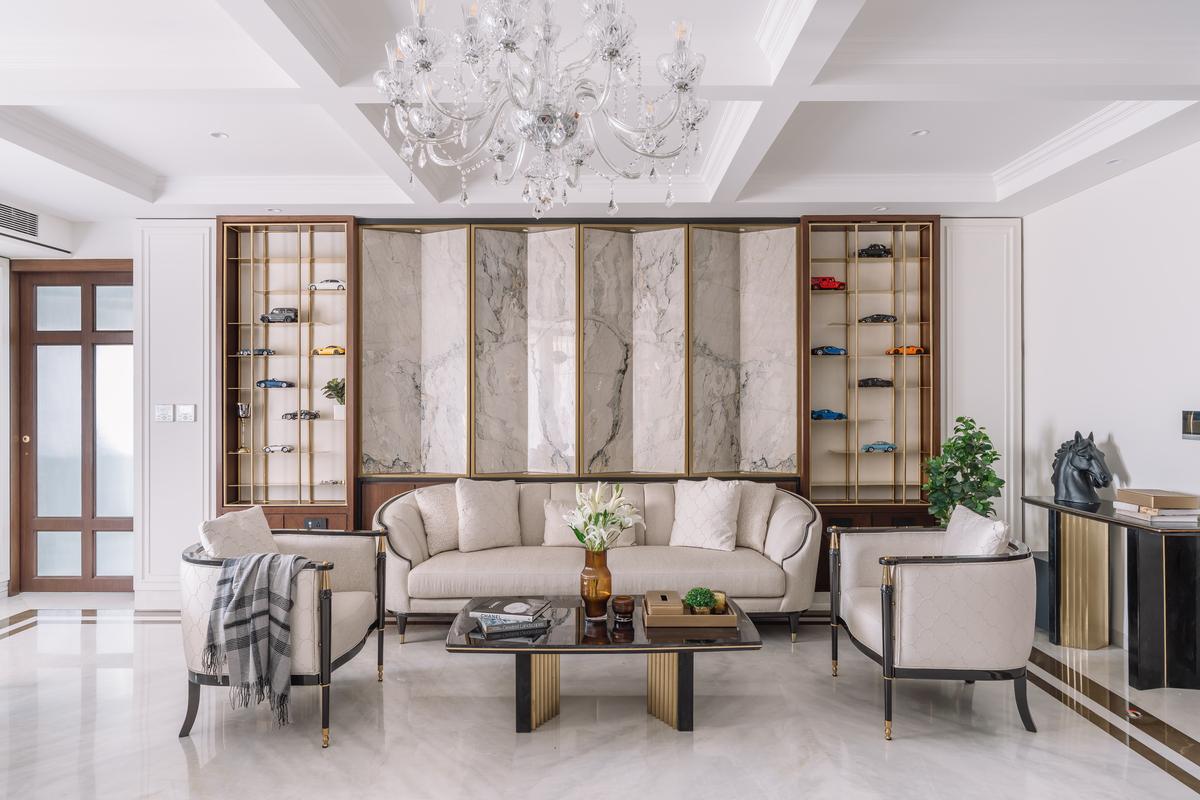 Book matched marble cladding takes centre stage in this living room statement wall. 