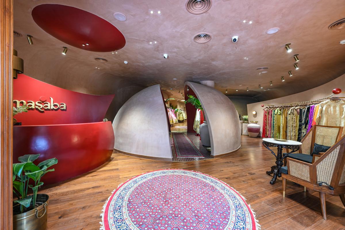 The store is a cave-like structure with terracotta-tinted walls with splashes of red, maroon and burgundy. The store is a cave-like structure with terracotta-tinted walls with splashes of red, maroon and burgundy.