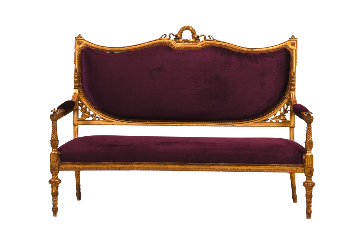 Luxurious purple upholstery paired with hand-carved gold accents. Luxurious purple upholstery paired with hand-carved gold accents.
