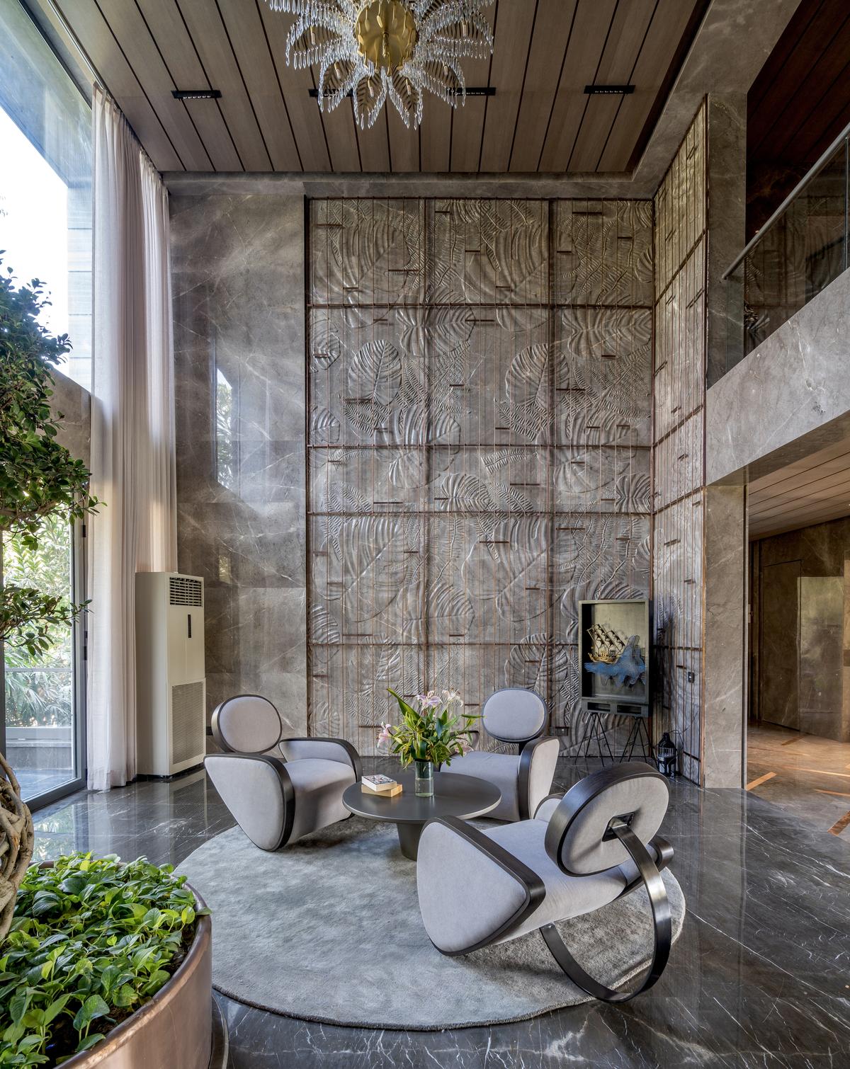 Italian marble cladding with intricate foliage patterns adorn this indoor statement wall. 