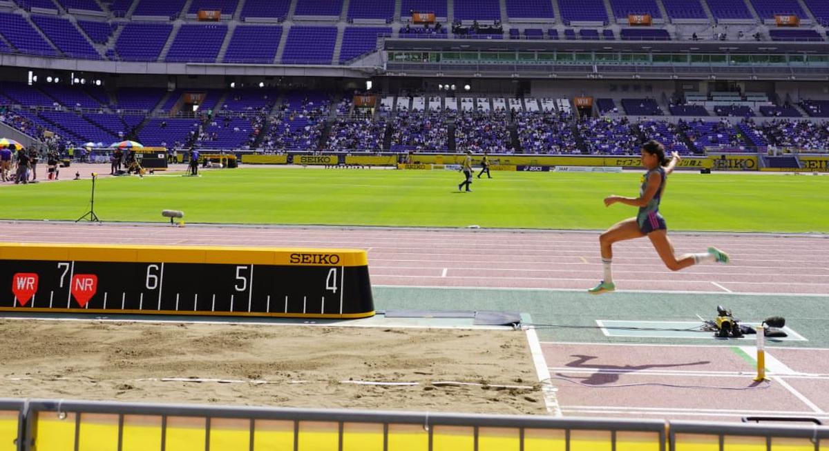 Shaili makes her bronze-winning leap.