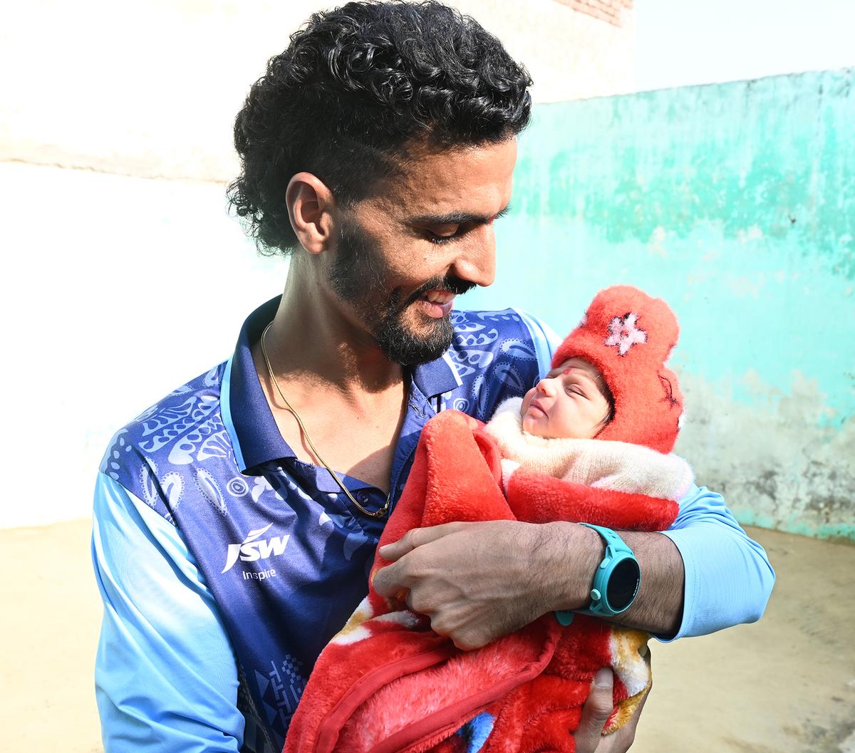 Gulveer with his daughter at his residence in Sirsa village in Uttar Pradesh.