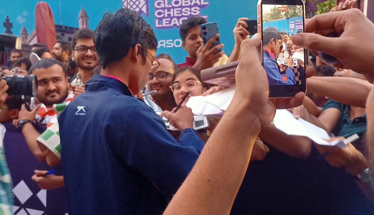 R. Praggnanandhaa signing autographs for fans. 