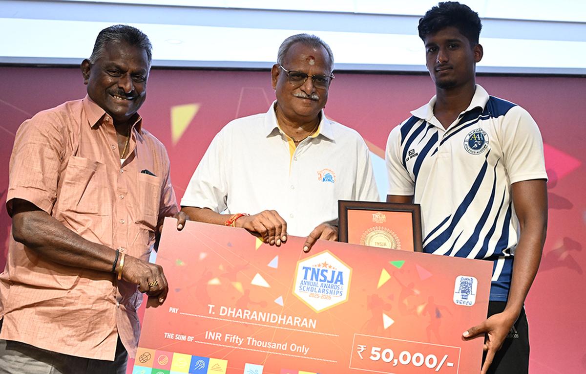 Dharanidharan receives the scholarship from V. Baskaran and K.S. Viswanathan.