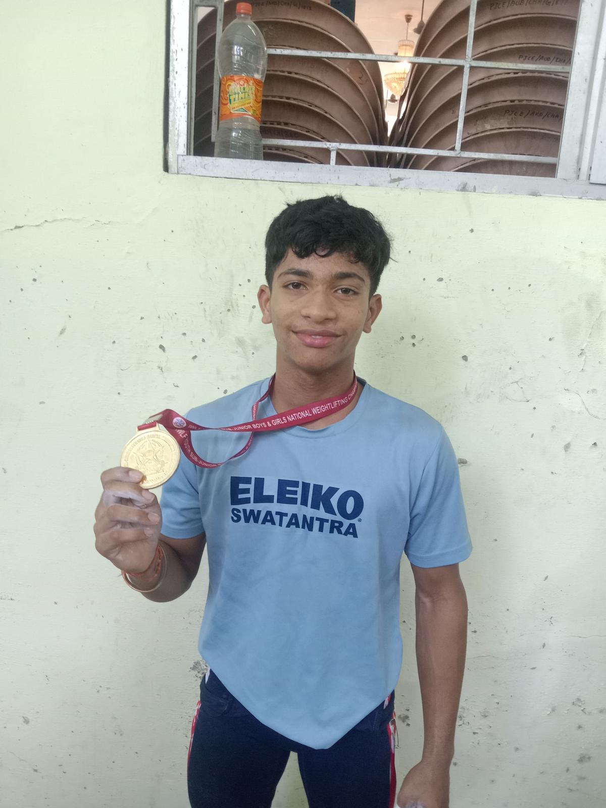 Dhanush with the men’s 49kg gold medal in the National (junior, youth & senior) weightlifting championships at Nagercoil.