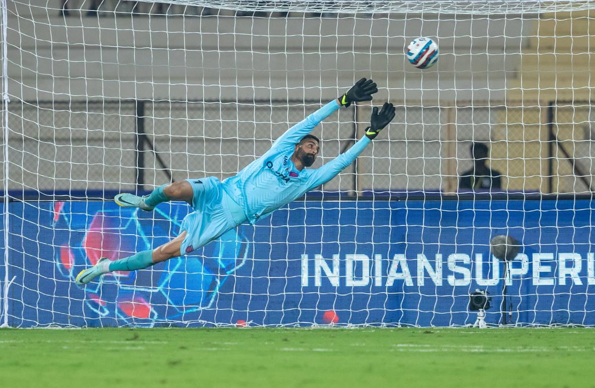 Amrinder Singh of Odisha FC dives to make a save from a Hyderabad FC effort in the Indian Super League football match at the G.M.C. Balayogi Athletic Stadium, Hyderabad, on November 5, 2022.