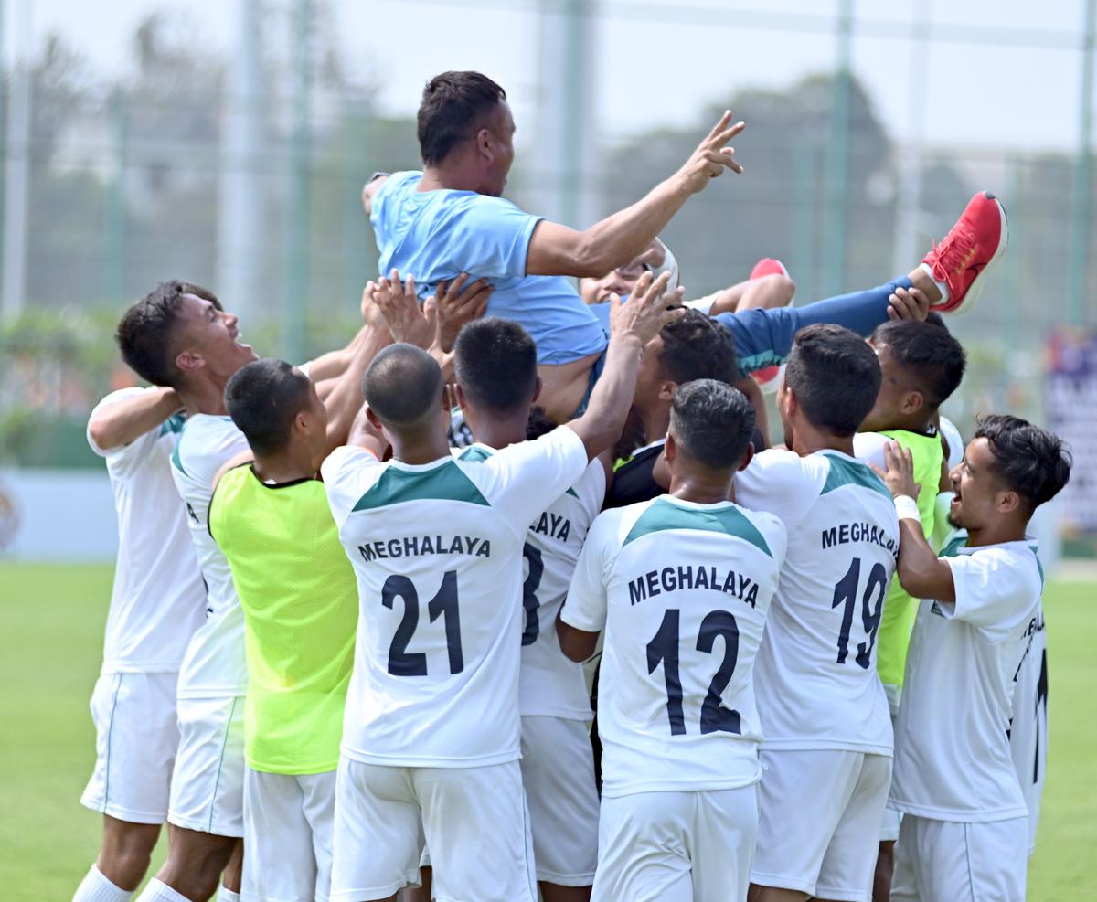  Meghalaya players celebrate their maiden Santosh Trophy semifinal entry by tossing their coach Khlain Syiemlieh in the air in Bhubaneswar on Monday. Photo: AIFF