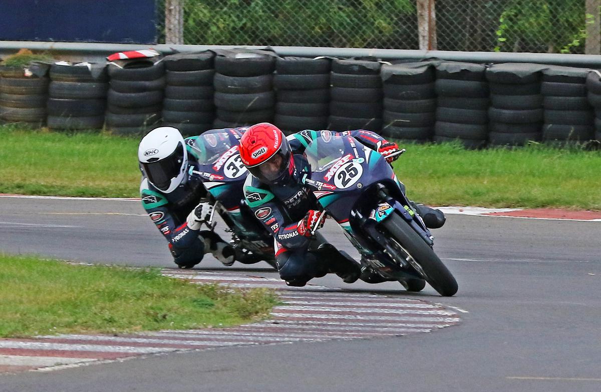 Hugging the tarmac: Deepak Ravikumar (No. 25) on way to winning the Pro-Stock 165cc race. 