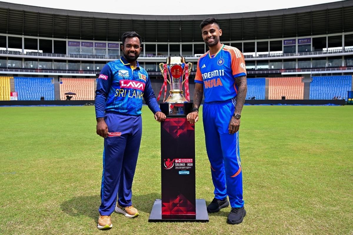 Sri Lanka’s captain Charith Asalanka and his Indian counterpart Suryakumar Yadav pose with the Twenty20 trophy in Kandy on July 26, 2024.